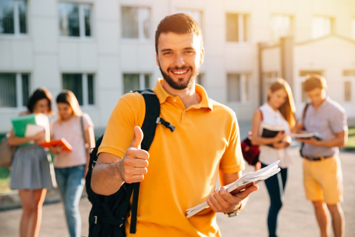young-attractive-smiling-student-showing-thumb-up-outdoors-campus-university (1) Sustainable Educational Practices: Balancing Profit and Purpose